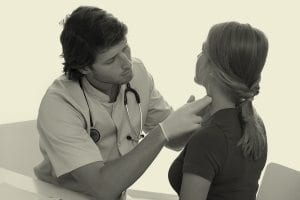 Doctor cheacking a woman Thyroid